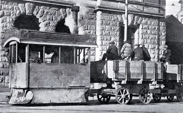 Image: A Kitson steam tram runs past the Government Buildings in Cathedral Square with tramways workers on board