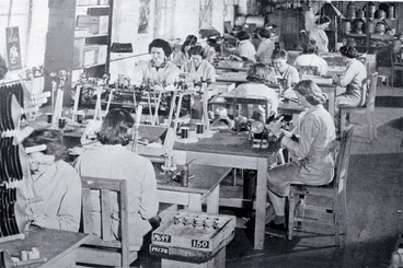 Image: Girls in a small workroom engaged on assembly work