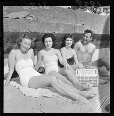 Image: Unidentified swimmers listening to radio and relaxing at Oriental Bay Beach, Wellington, showing Philips radio