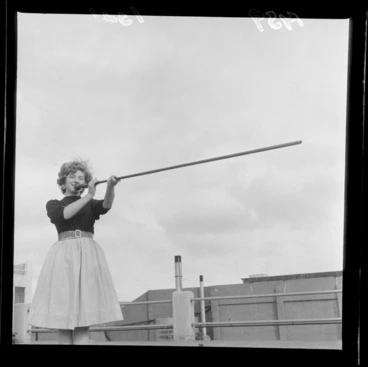 Image: Malayan terrorist weapons, a woman demonstrating how to use a blowgun