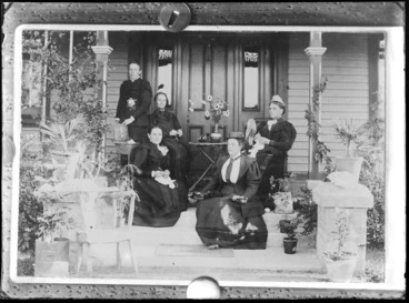 Image: Group of five unidentified women on the steps of a house, two of the women are doing crochet and one woman knitting, various pot plants can be seen on the steps and in front, probably Christchurch district