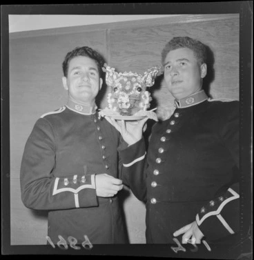 Image: Two unidentified men holding a platter with a pig's head on it at a Festival Ball