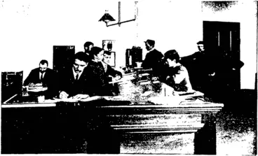 Image: DESPATCH ROOM OF THE TELEGRAPH OFFICE. Clerk in charge W Houston, assistant despatch clerks, R. T. Hutcheson and L. H. M'Dermott.  (Photos by Gny.> (Otago Witness, 05 November 1902)