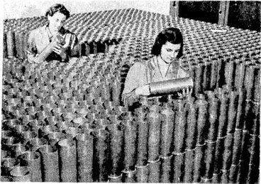 Image: Are we downhearted? It is easy to guess the ansiver of these soldiers of the Maori Battalion, who are amongst the N.Z.E.F. Forces in the Middle East. Each day brings a faster tempo to Canadian war industry, and more women are being absorbed into the country's munitions factories. These girls are inspecting shell cases in one of the large plants. (Evening Post, 10 June 1941)