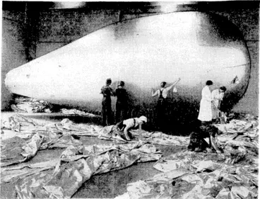 Image: Barrage balloons in the making. An almost complete balloon is seen in the background under air-pressure test at one of the factories working for the Ministry of Aircraft Production. This factory ivas previously engaged in making women s wear. (Evening Post, 22 October 1941)