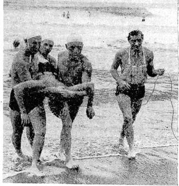Image: R.X.Z.A.F. Photo. A .rescue from the surf at Bougainville Island by an R.N.Z.A.F. lifesaving team. The team ivas in the process of making a practice rescue when events took a grim turn. There ivas a cry from the surf and a rescue ivas quickly effected. The man is being brought to the beach by L J. North (Auckland), W. G. Dent (Westport),D. Sehvyn (Auckland), and W. King (Whangarei). (Evening Post, 09 November 1944)