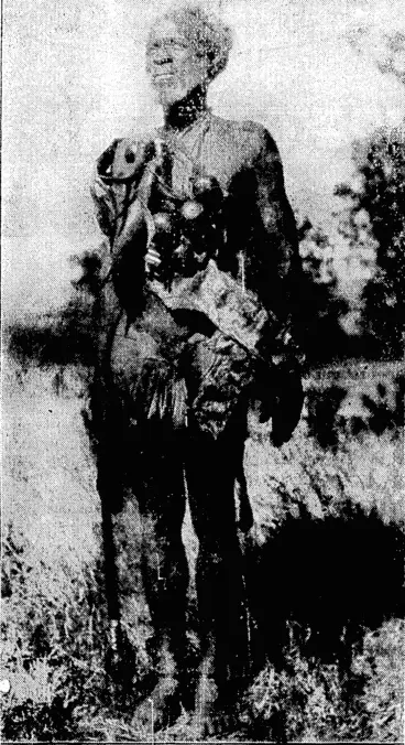 Image: A Zulu witch doctor, all coitipleta with medicine chest and float-horn bottles, as he appeared at a welcome to the All Blacks during the present tour of South Africa. (Evening Post, 04 August 1928)