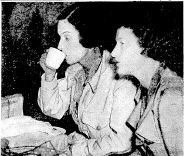 Image: TEA AFTER LONG FLIGHT.—Mm Jean Batten taking a cup of tea with another airwoman, Miss Nancy Bird, at.Sydney on Tuesday after the New Zealandcr's arrival from London on her recordbreaking flight. . (Evening Post, 17 October 1936)