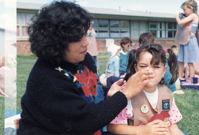 Image: Pippin Kylie Neilson receives an application of sunblock from her Mum, Peka Neilson.