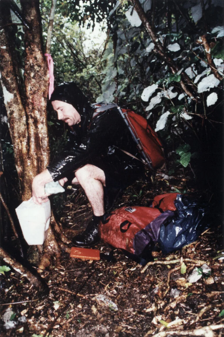 Image: Possum control; Mark Rossiter, Forest and Bird Society, fills a 1080 bait station.