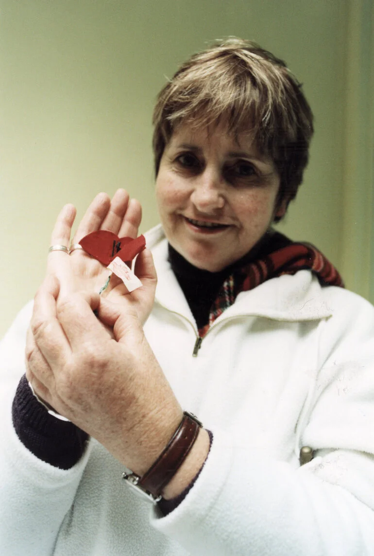 Image: Anzac Day 2002; Lynda Mathews with poppy from 1947.