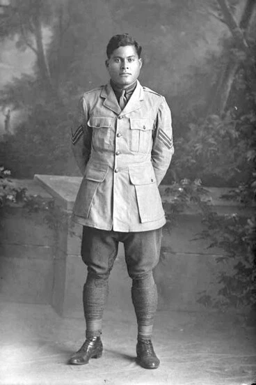 Image: Full length portrait of Corporal Harry, probably (private in the roll) Purie Dave Harry, Reg No 16/1371, of the 3rd Maori Contingent, Rarotongans, New Zealand Maori Pioneer Battalion.