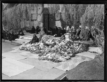 Women on porch with wreaths & coffin Image: Women on porch with wreaths & coffin