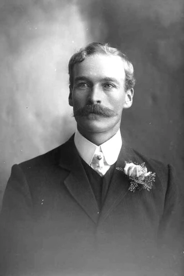 Image: 1/2 portrait of Mr Kavanagh, who has a moustache and is wearing....