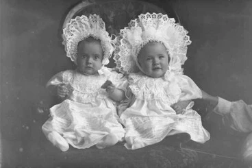 Image: Full portrait of Mullins babies (twins?) seated on a chair....