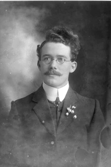 Image: 1/4 portrait of Mr Jenkins who is wearing spectacles and has....