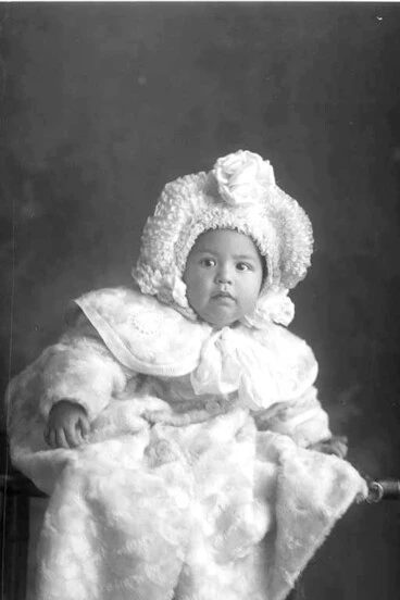 Image: Portrait of the Phillips baby who is wearing a large ruffled....