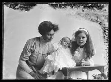 Image: 3/4 length portrait of a woman, a girl and a baby in the Culpan group.