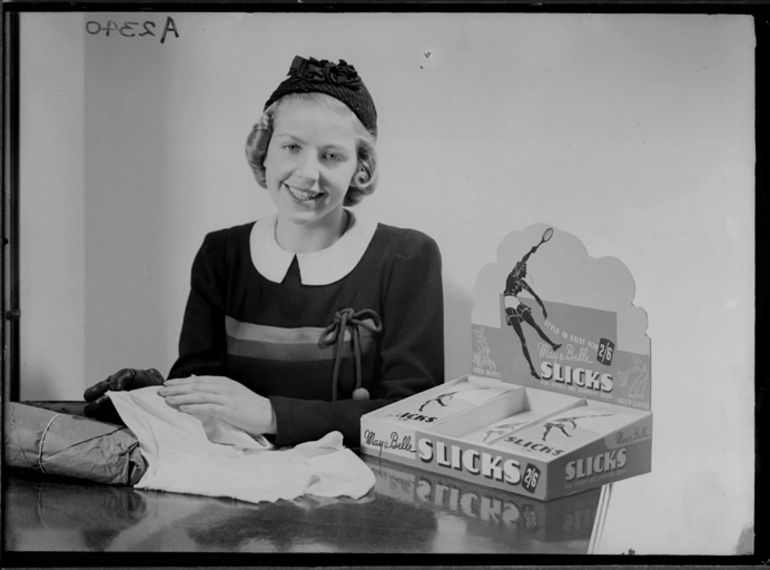 Image: Showing a model seated beside an advertising stand for May and Belle underwear, for Dormer Beck Advertising 1930