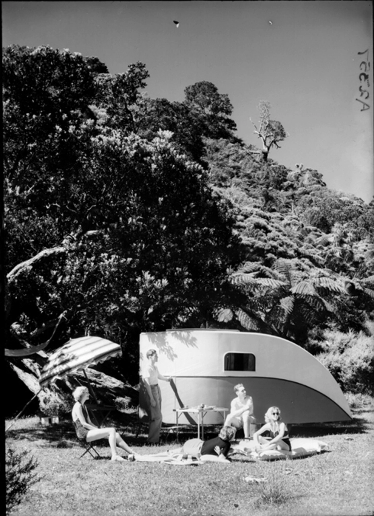 Image: Showing people picnicking beside an Aquires caravan 1940?