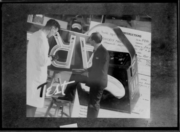 Image: Showing a man demonstrating neon signs for Rayneon, 1941