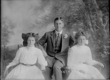 Image: 3/4 length portrait of Upton family group, the man seated in....