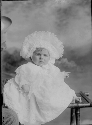 Image: Full length portrait of baby C Yonge, seated on a table,....