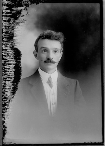 Image: 1/2 portrait of Mr Strange who has a waxed moustache....