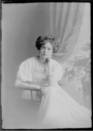 Image: 3/4 length portrait of Miss Vear, seated in a wooden chair,....