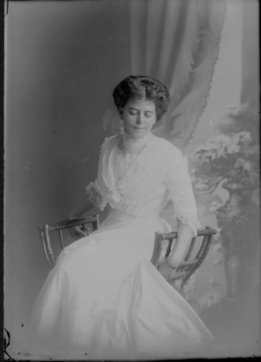 Image: 3/4 length portrait of Eileen Lois Clayton seated on a wooden chair,....