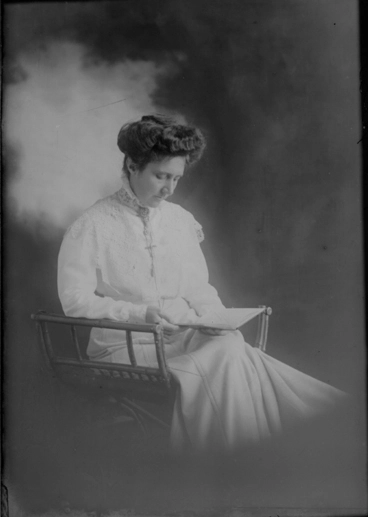Image: 3/4 length portrait of Miss Laird, seated in a wooden chair....