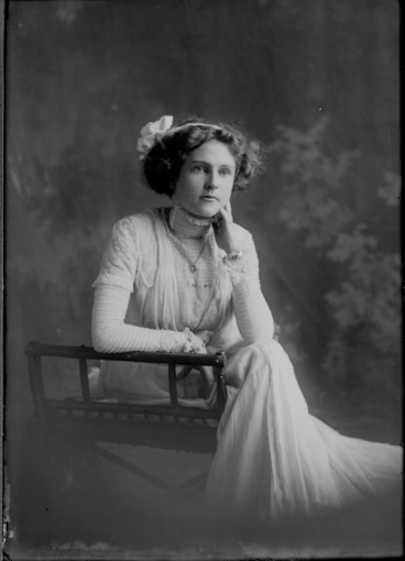 Image: 3/4 length portrait of Miss Land,seated in a wooden chair,....
