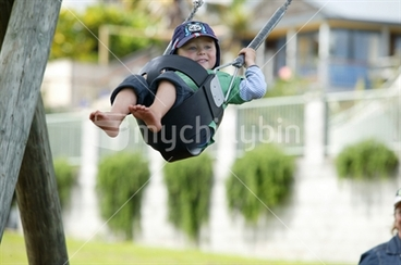 Image: Young boy enjoying a swing