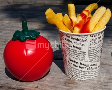 Image: Hot Chips in a container next to a Tomato shaped Tomato Sauce Container