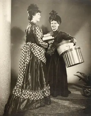 Image: (Two woman in period dress holding books and hat boxes)