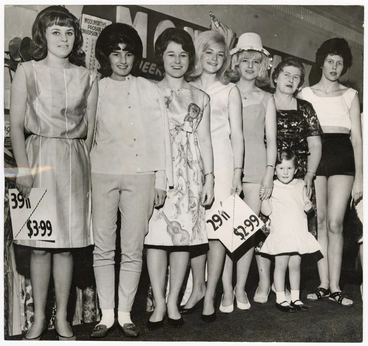 Models holding decimal price tags, Woolworths Image: Models holding decimal price tags, Woolworths