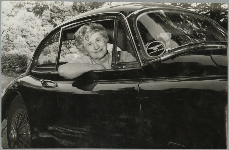 Image: Ngaio Marsh sitting in her Jaguar XK150