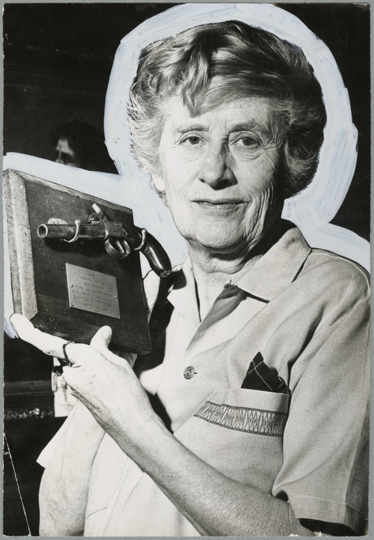 Image: Ngaio Marsh holding a mounted pistol