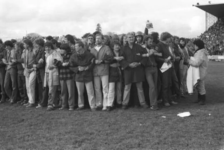 Image: Group of protestors including Geoff Chapple in middle of rugby field. Anti Springbok Tour protest march, Hamilton