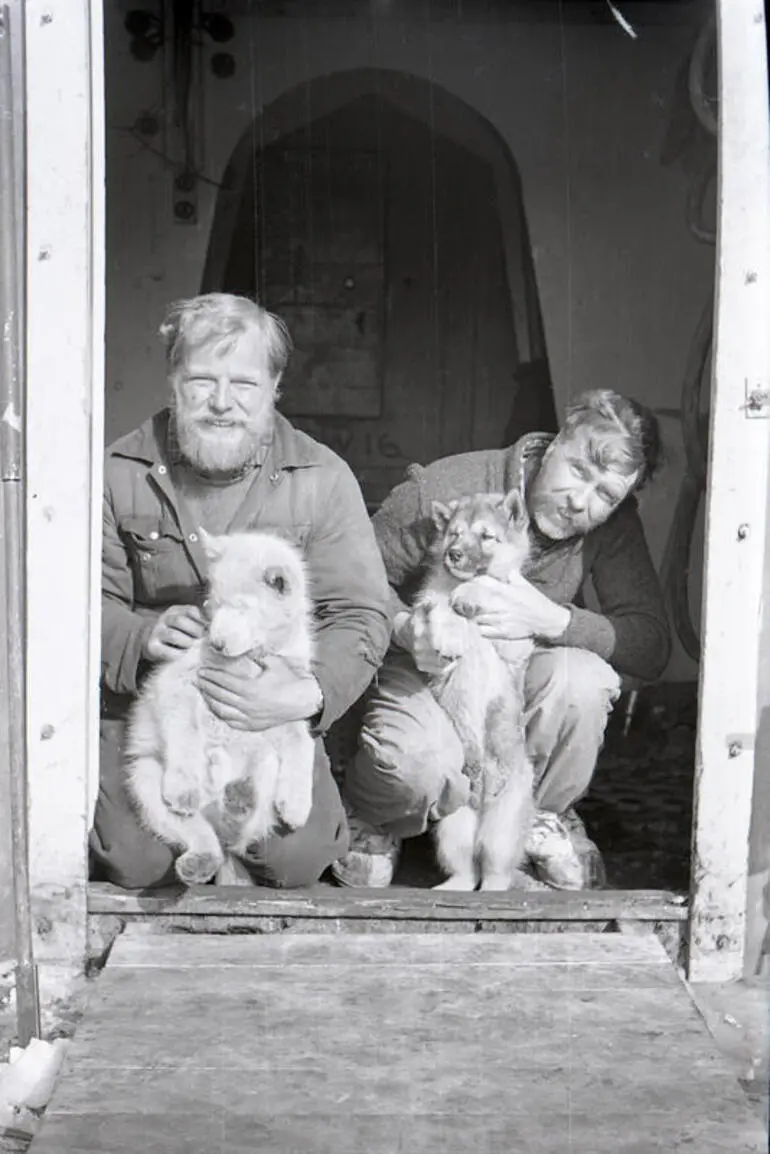 Image: Negative: Men and puppies