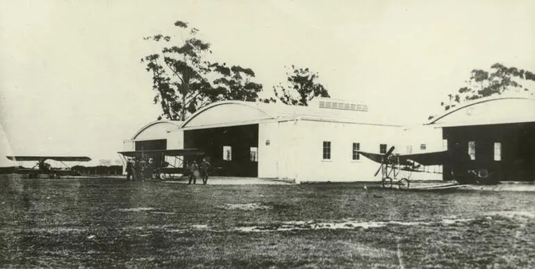 Image: Black and white photograph of the hangars containing Caudron planes at the Canterbury Aviation Company