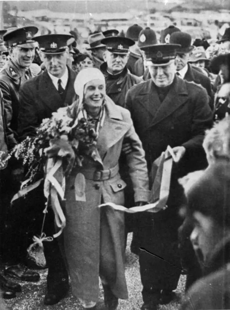 Image: Jean Batten surrounded by officials and supporters at the conclusion of her England - New Zealand flight