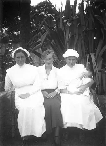 Image: Woman and two nurses with baby