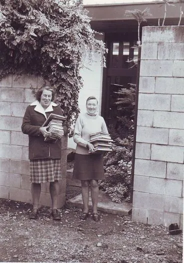 Image: Pam Lyon and Elaine Morse carrying new stock into library, mid 1970's