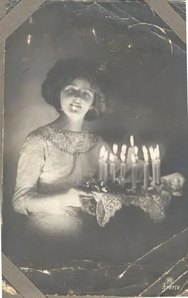 Image: Young woman with birthday cake. c1914-18.