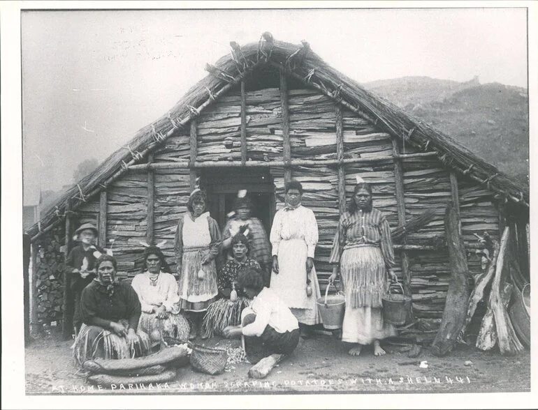 Image: At home, Parihaka, woman scraping potatoes with shell