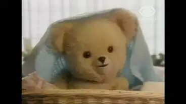 Image: HUGGIE FABRIC SOFTENER. TEDDY BEAR IN A BASKET