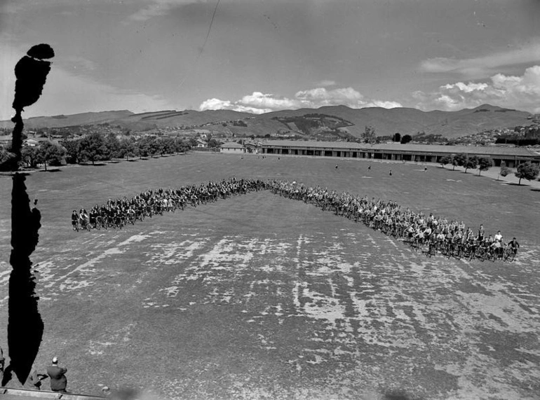 Image: Education, Unidentified Primary School Children Cyclists in V Formation with their Bicycles. Port Hills Behind. Christchurch, Canterbury, New Zealand.