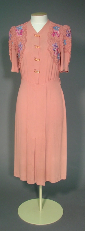 Image: Day dress; pink fabric with floral details and braiding