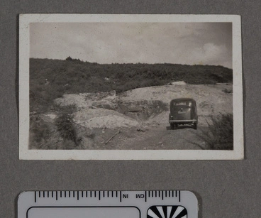 Image: Photograph - Car parked by a clay quarry in countryside